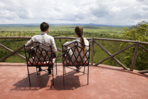 Couple on a game drive safari in the Serengeti, Tanzania