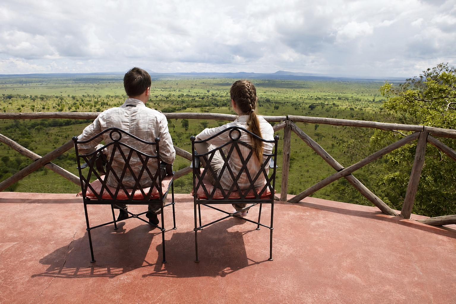 Couple on a game drive safari in the Serengeti, Tanzania