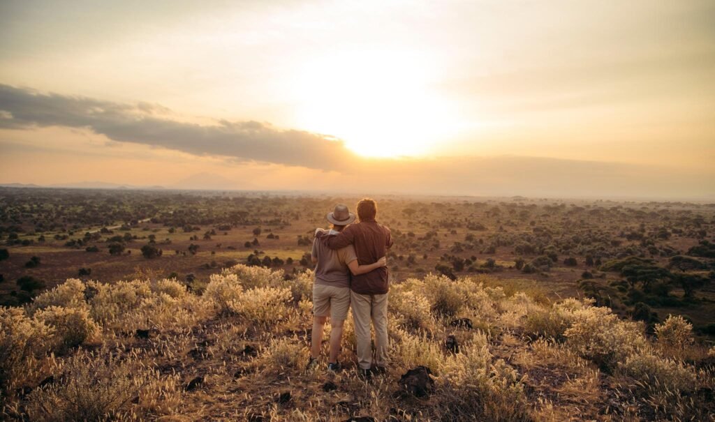 Couple enjoying Tanzania safari in June while watching wildlife in Serengeti National Park