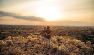 Couple enjoying Tanzania safari in June while watching wildlife in Serengeti National Park