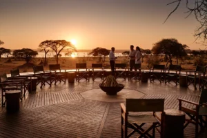 Couple relaxing at safari lodge in Tanzania during December safari overlooking scenic African wilderness 